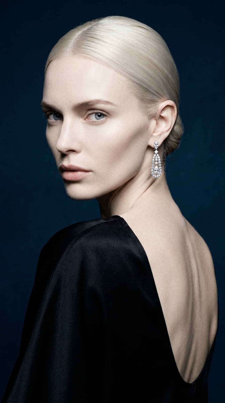 selene rear three-quarter, slicked platinum hair structure, cold luxury aesthetic