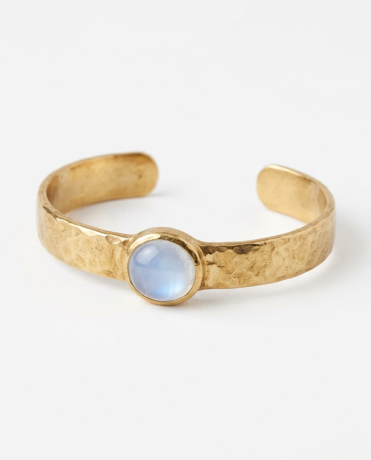bracelet photographed with bling ai — hammered gold, moonstone cuff