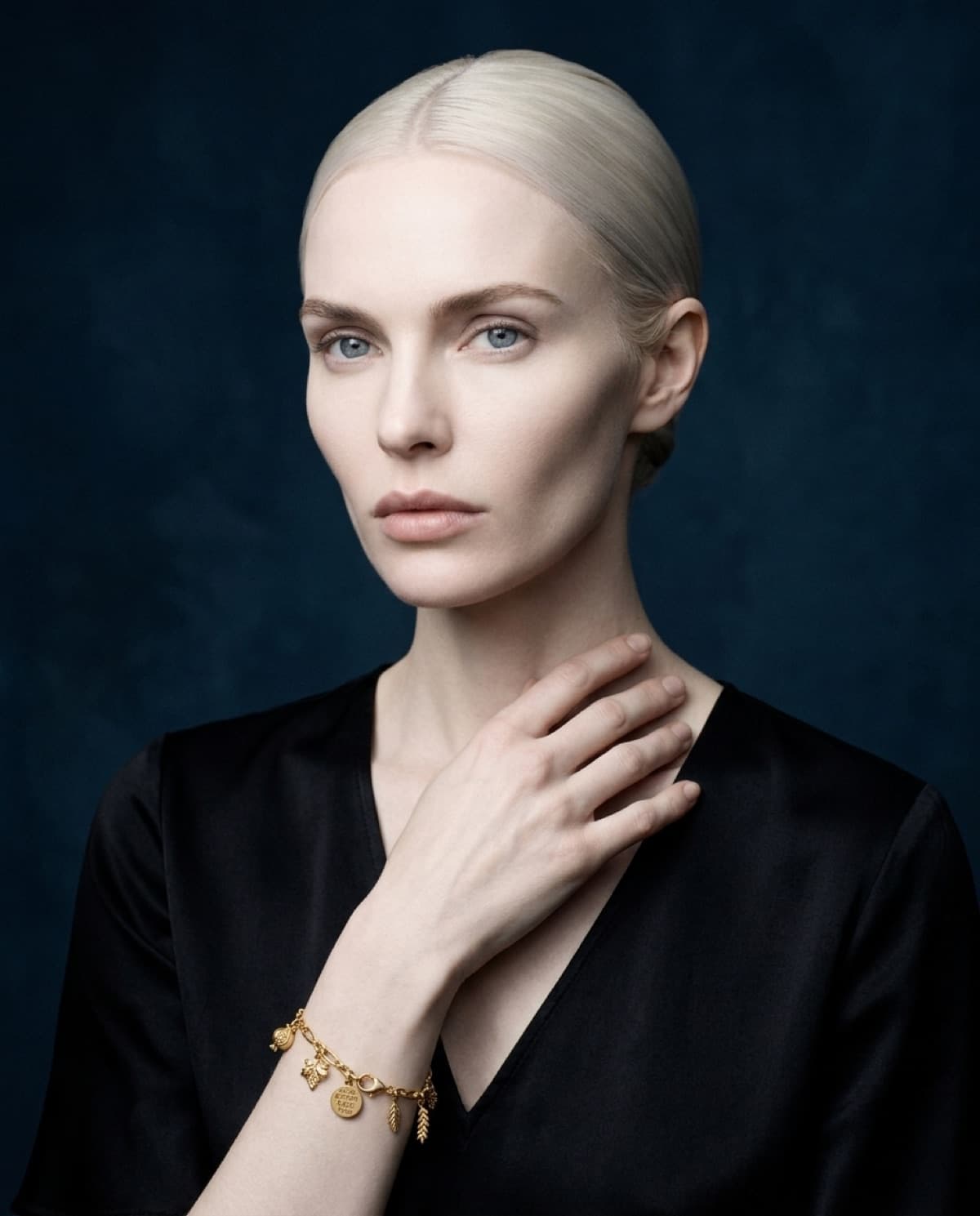 bracelet photographed with bling ai — selene, charm bracelet, cold navy