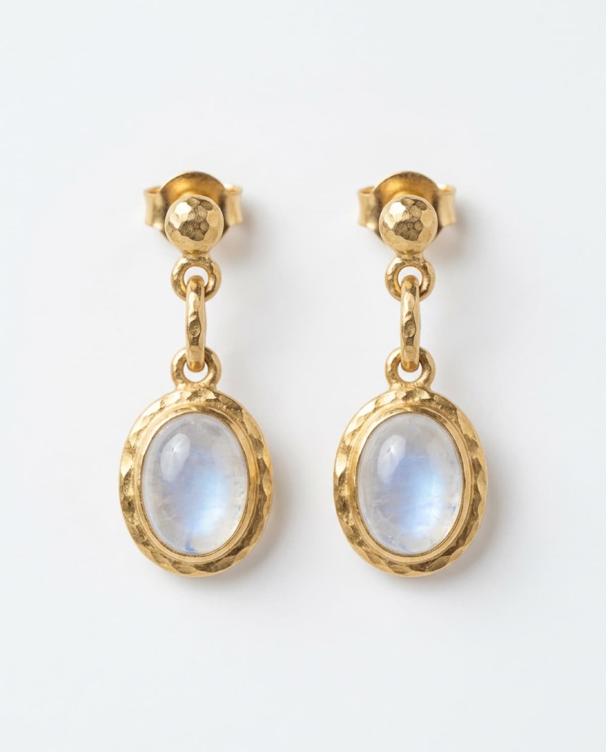 earring photographed with bling ai — hammered gold, moonstone drops
