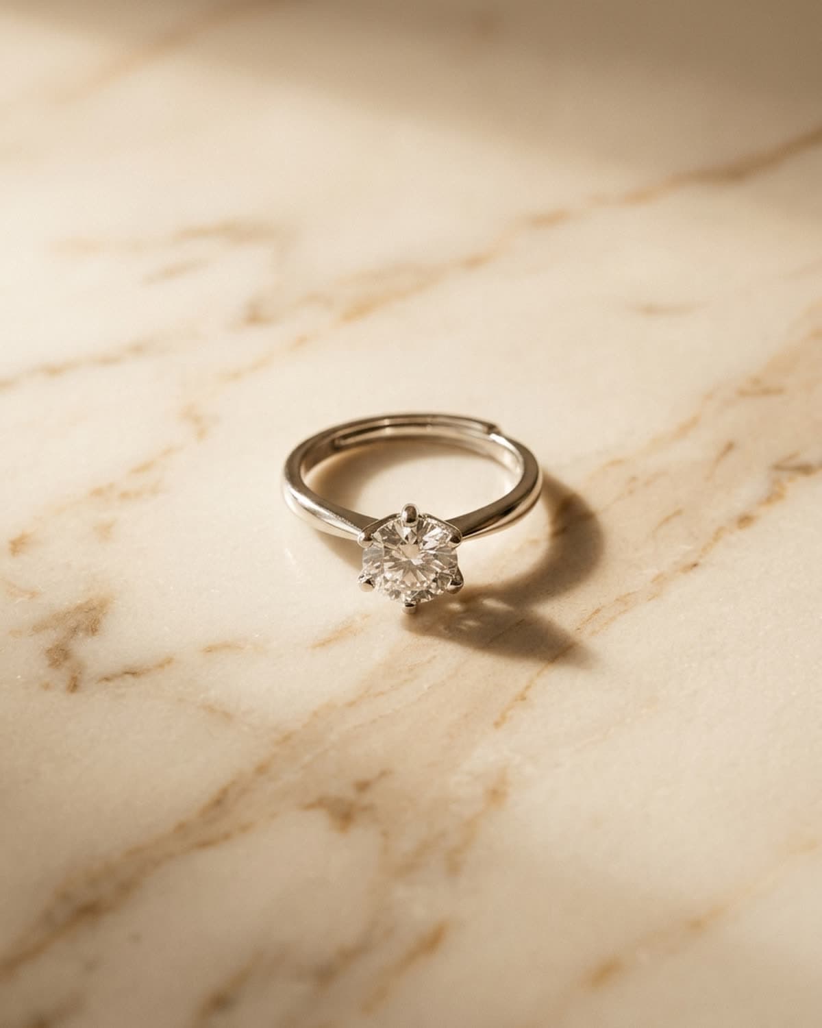 overhead jewelry photographed with bling ai — warm marble surface