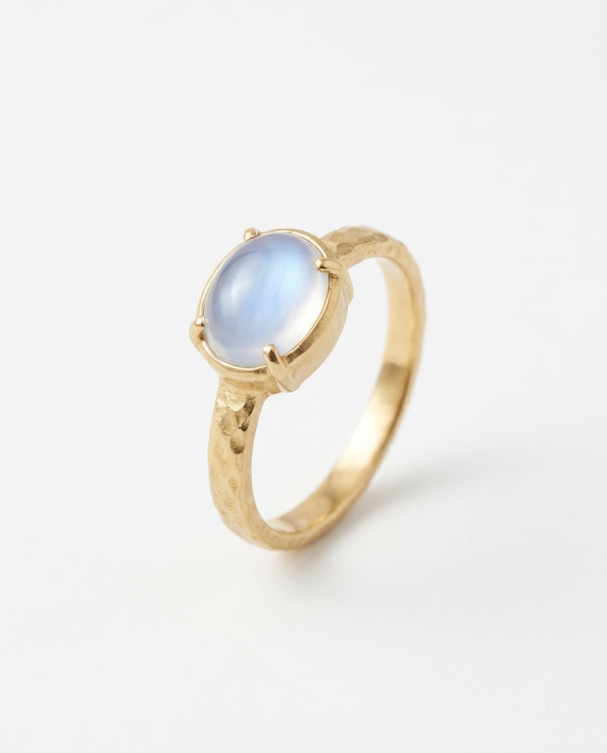ring photographed with bling ai — hammered gold, moonstone cabochon